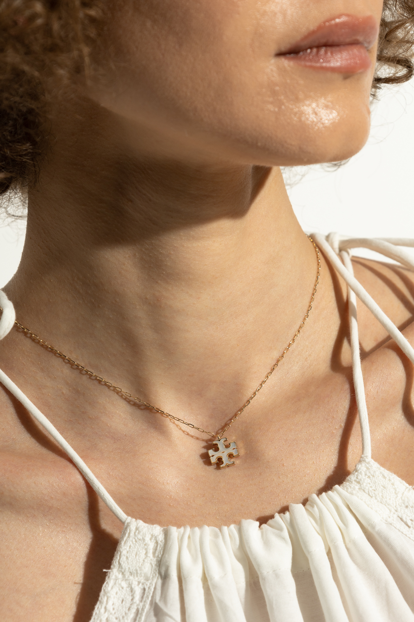 Tory Burch Necklace with a pendant in the shape of a logo